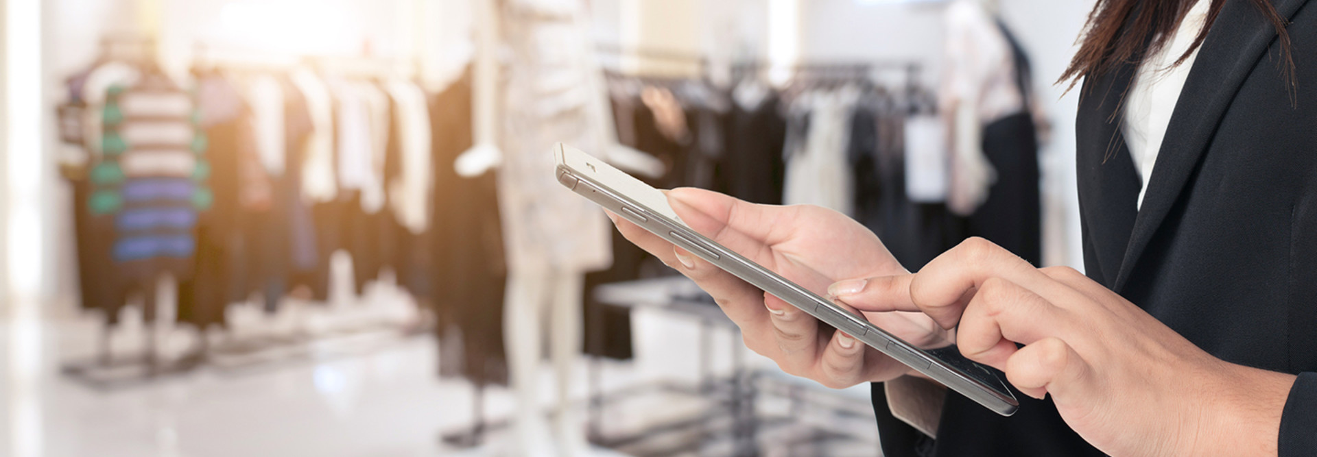 A user with a smartphone in a retail store. 