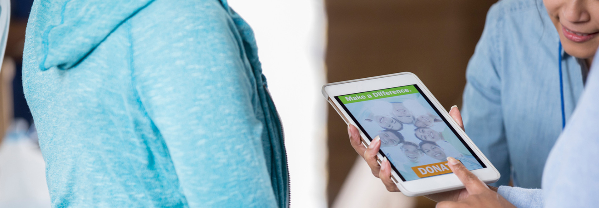Nonprofit worker takes a mobile donation on a tablet 