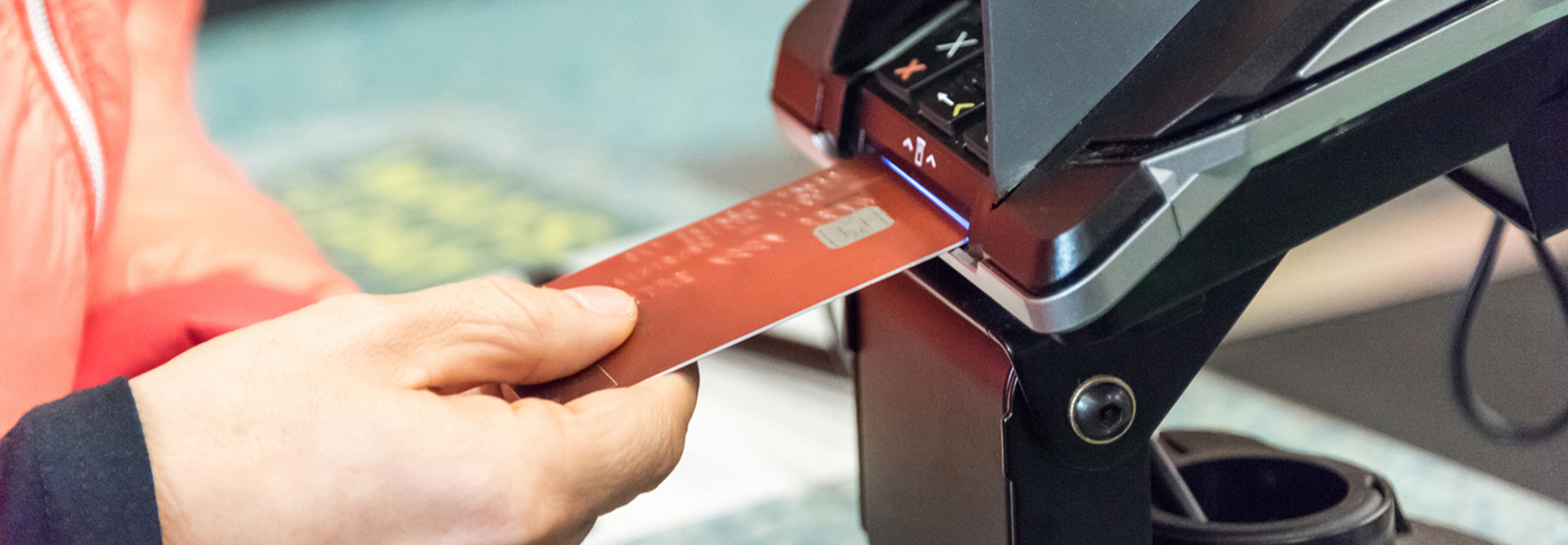 Man using credit card with a chip to pay at a store 