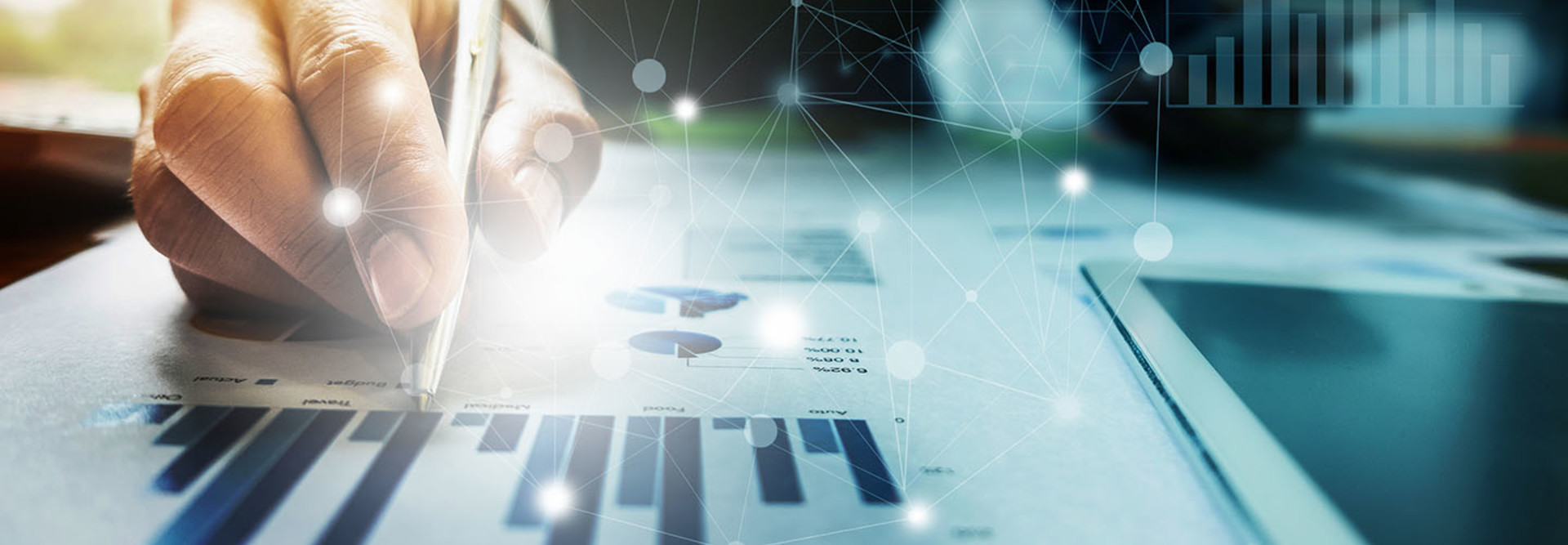 Close up Businessman hand holding pen and pointing at financial paperwork with financial network diagram.