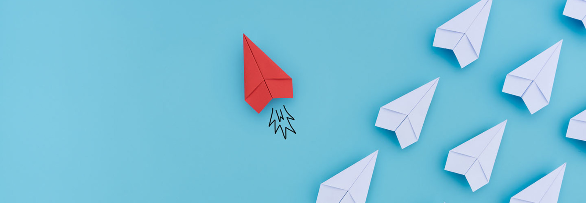 Group of paper planes in one direction and with one individual pointing in the different way. Business concept for innovative solution.