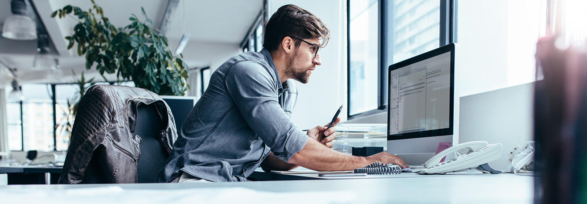 Man at computer in bright office