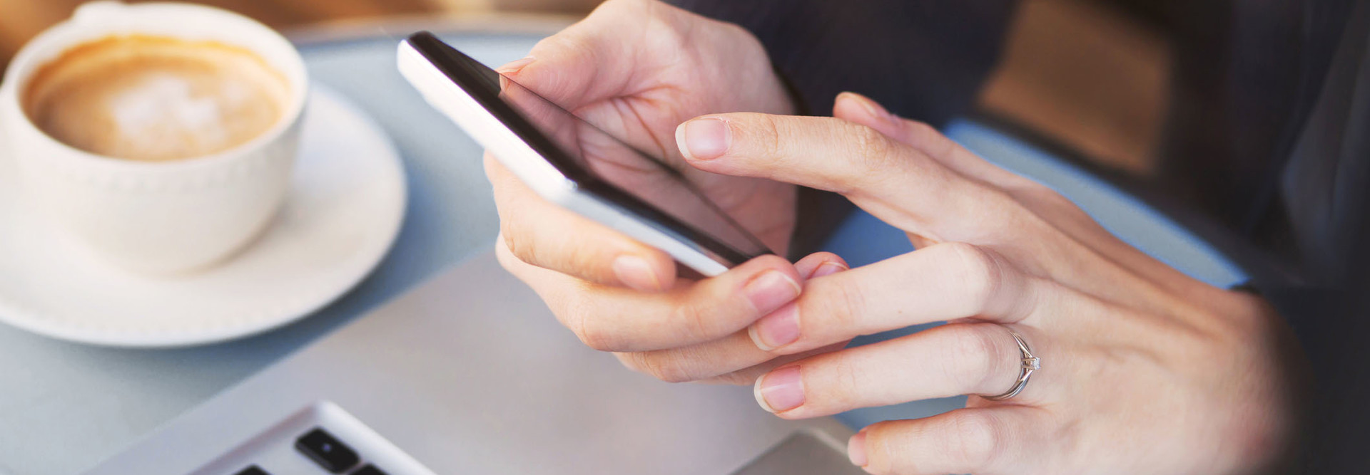 close up of hands using mobile application on smartphone, woman checking emails on her smart phone in cafe