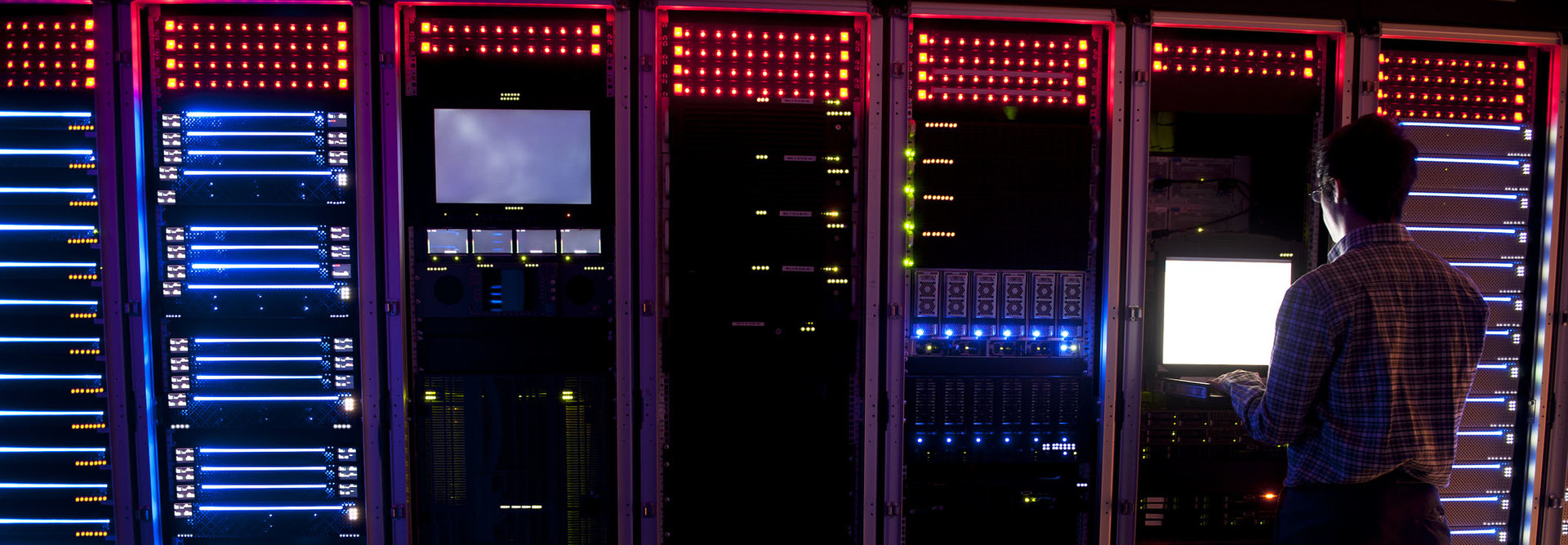 Modern interior of server room in datacenter. IT Engineer in Action Configuring Servers