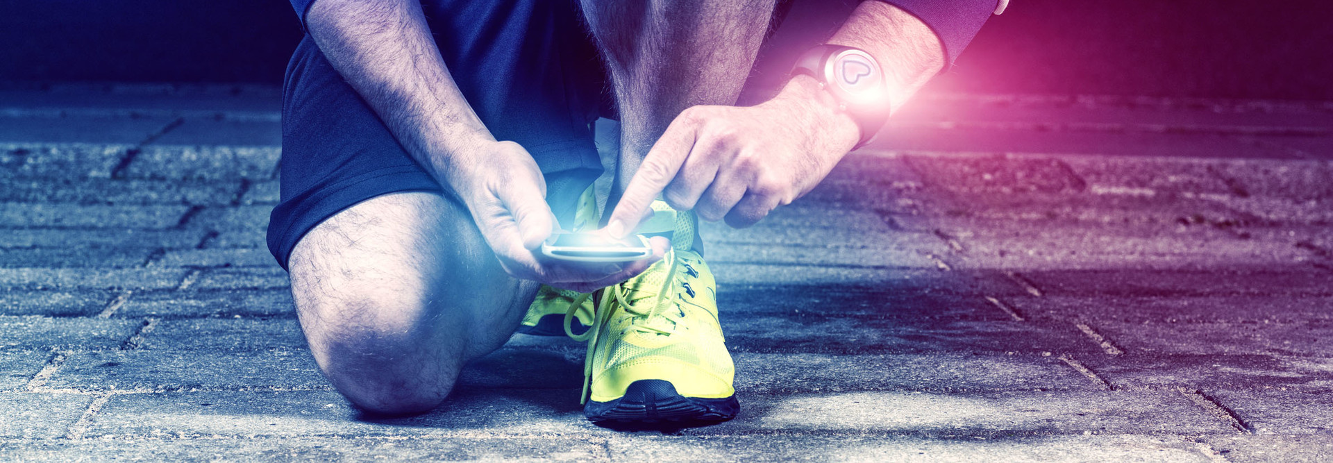 Runner uses mobile phone and smart watch with pulse tracking