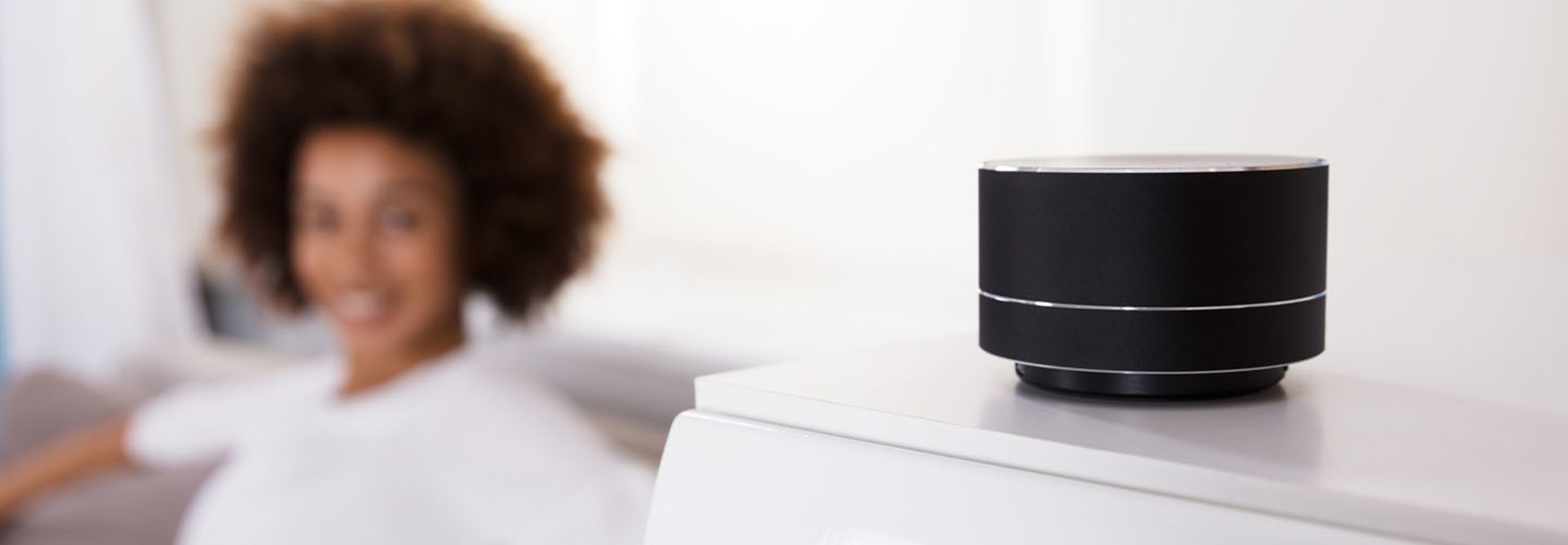 Close-up Of Black Wireless Speaker On Furniture
