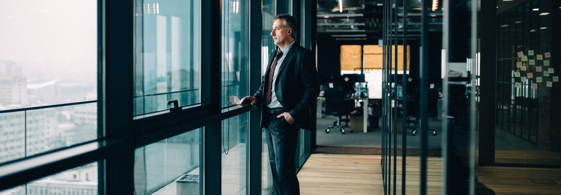 Senior businessman in suit looking out of window