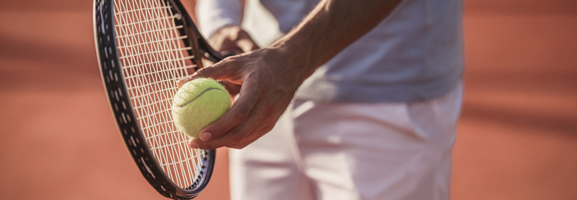 Man about to serve a tennis ball