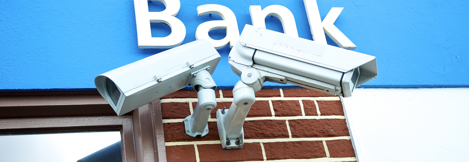 A bank protects its customers with two IP-enabled surveillance cameras