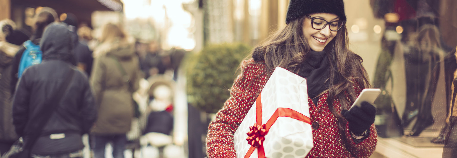 woman shopping in the city looking at her cell phone