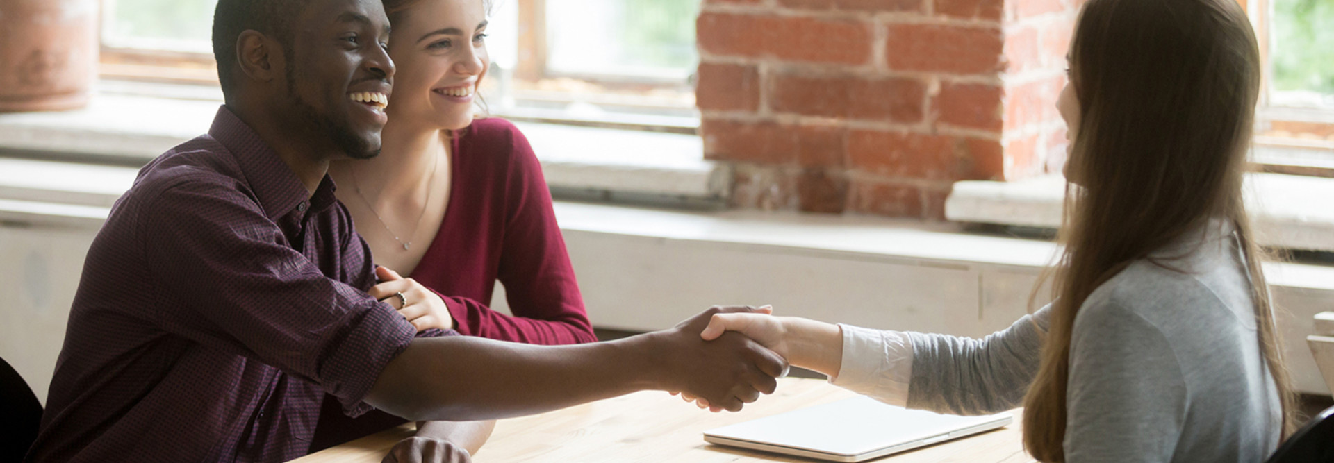 Young couple signing a mortgage document 