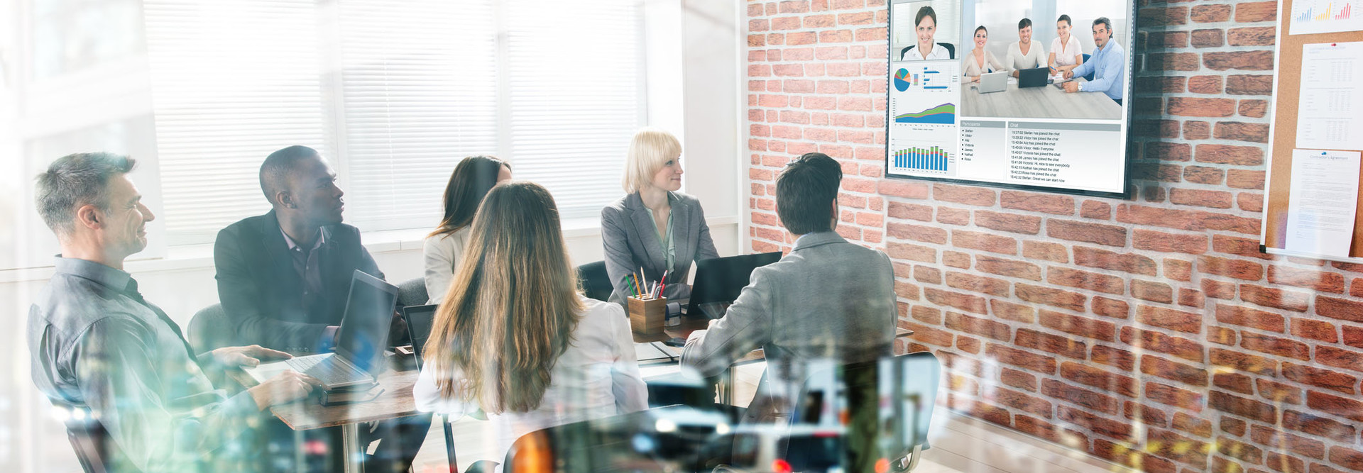 Group Of Businesspeople Having Video Conference In Boardroom