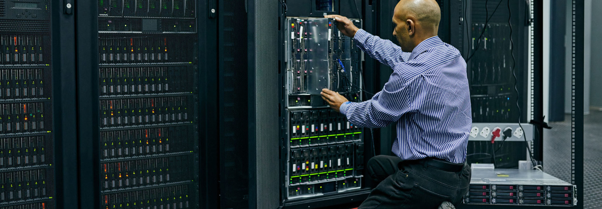 Shot of an IT technician repairing a computer in a data center