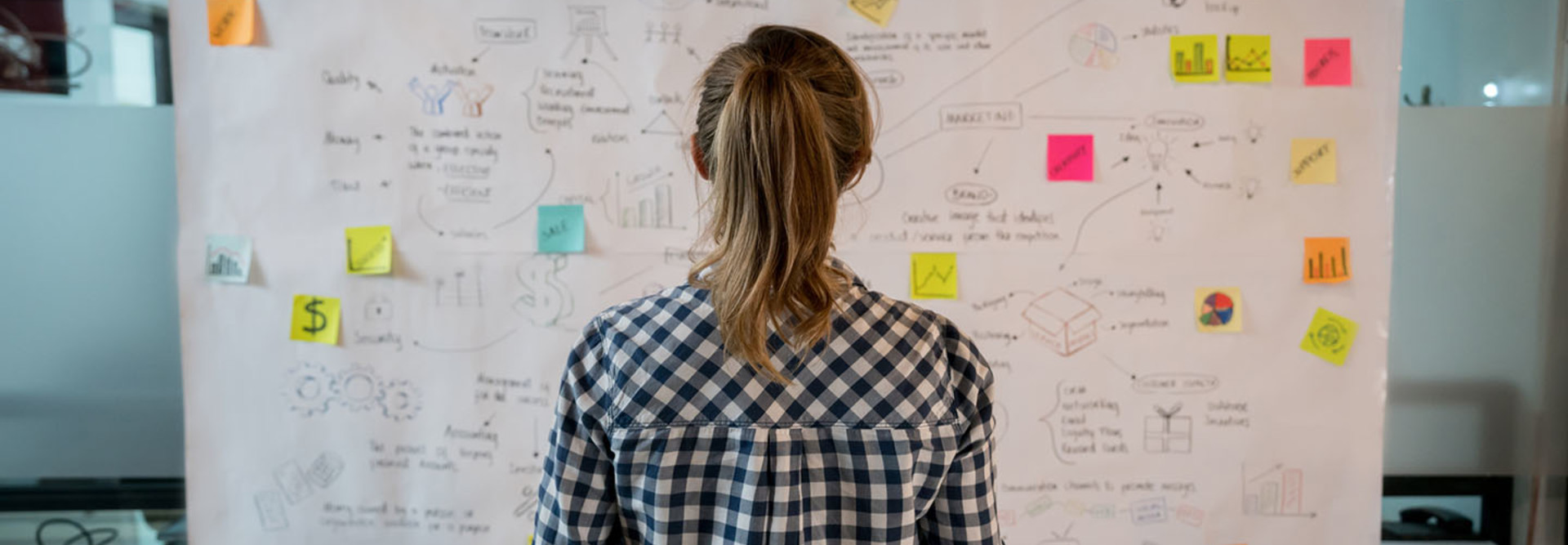 Woman sketching a business plan at a creative office
