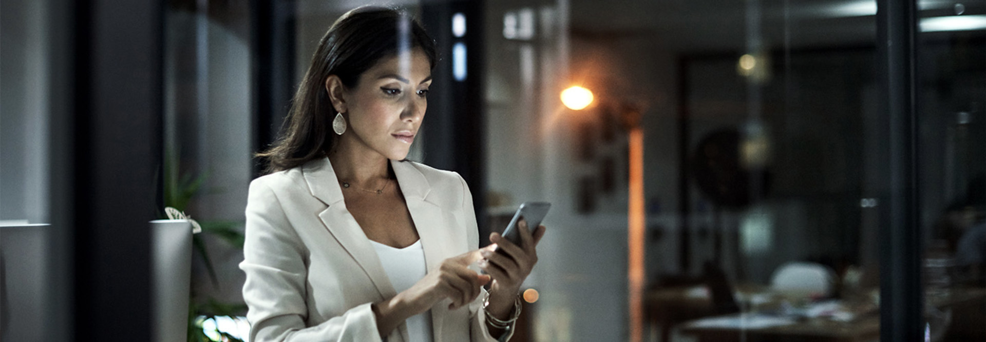 Person using mobile phone in office