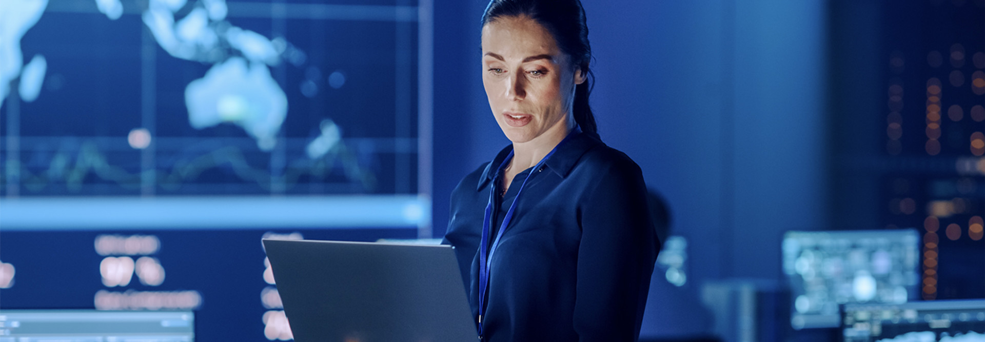 Project leader standing with laptop computer