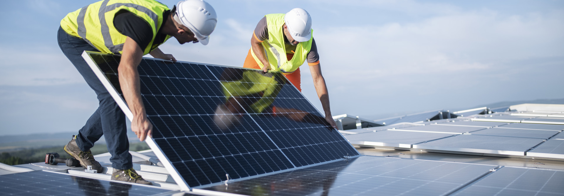 workers installing solar panels
