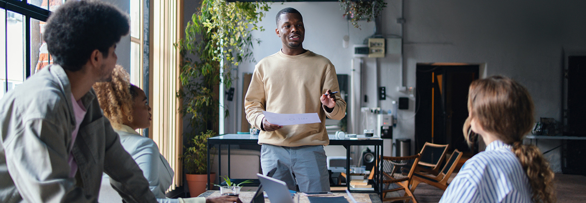 Man talking to 2 people from notes