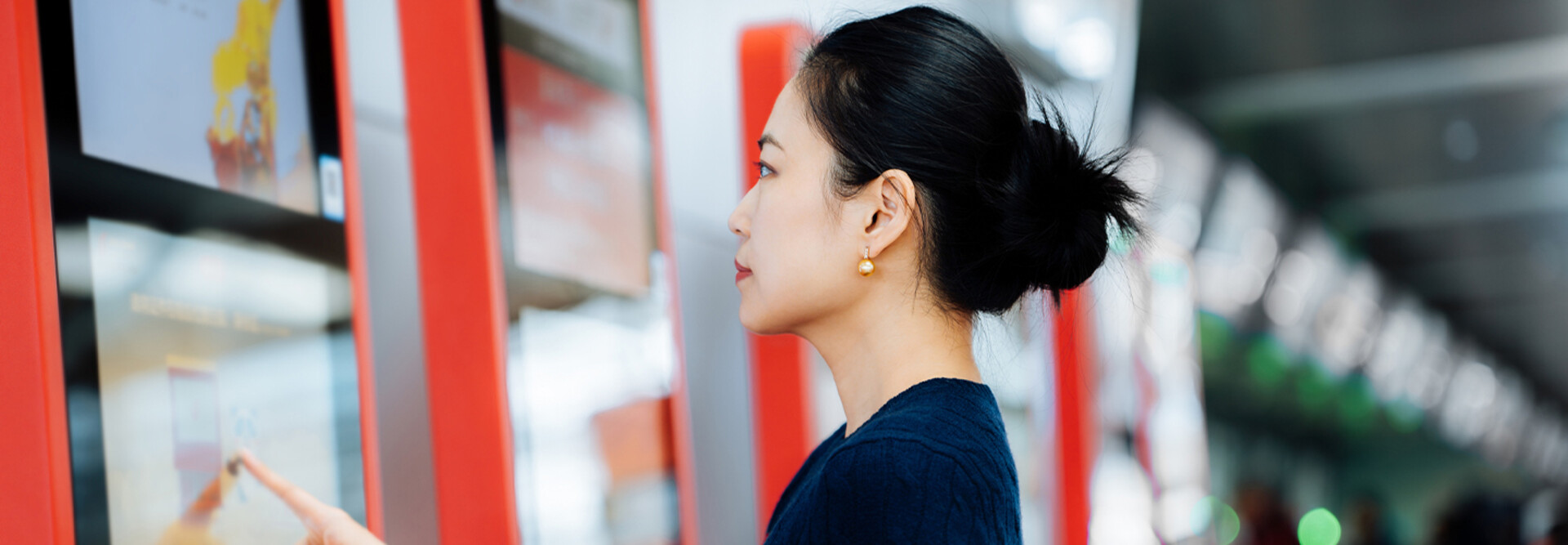 Person using touchscreen kiosk