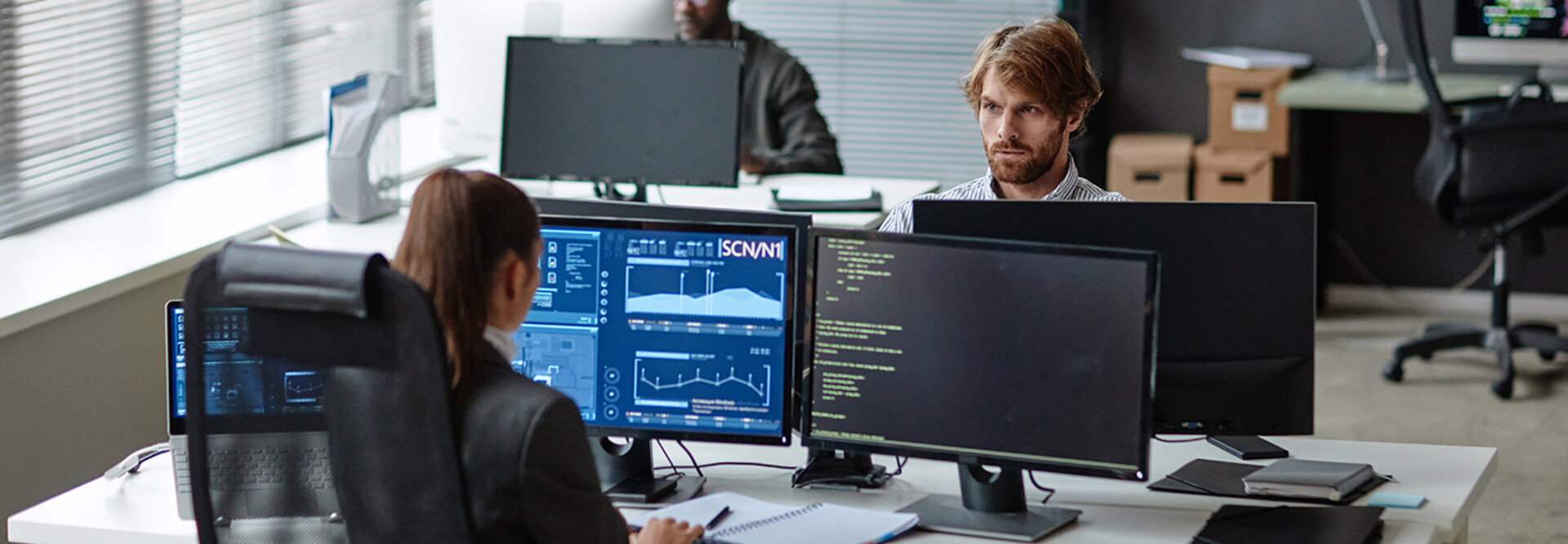 Young IT Developers Working with Multiple Computers