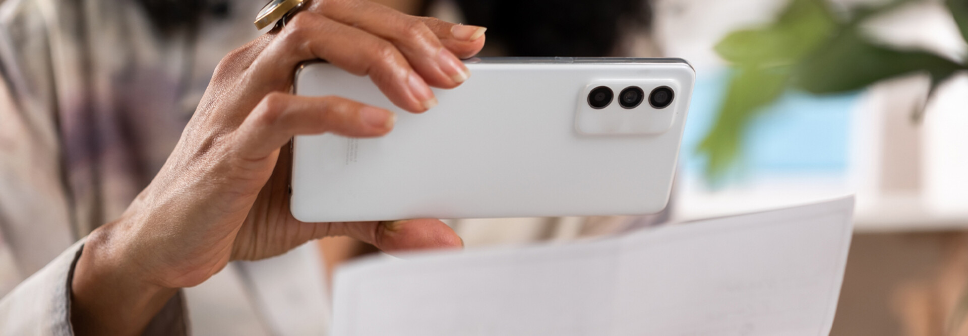 Person depositing check with cell phone