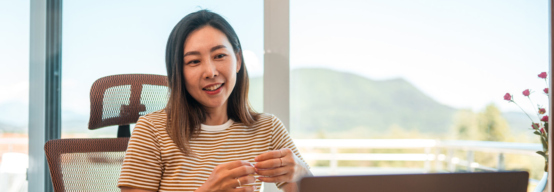 A woman works from home using AI and a laptop