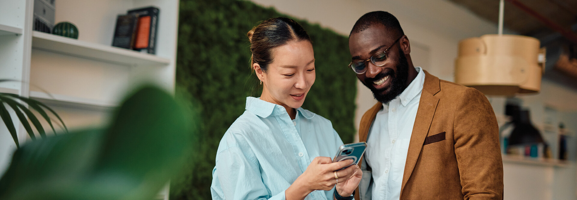 IT leaders holding an android phone in workspace