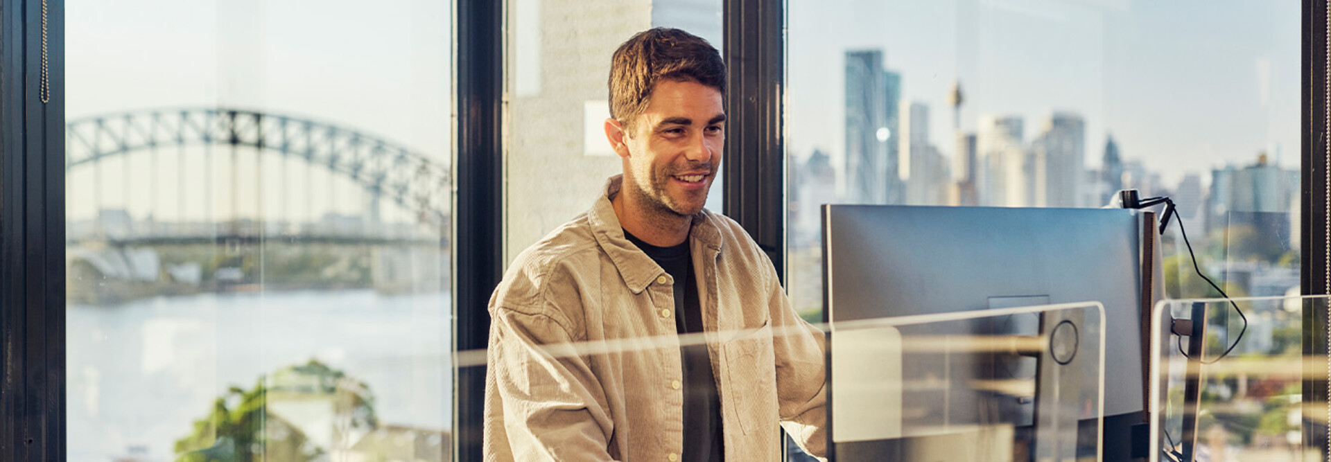 IT leader working on a large monitor display