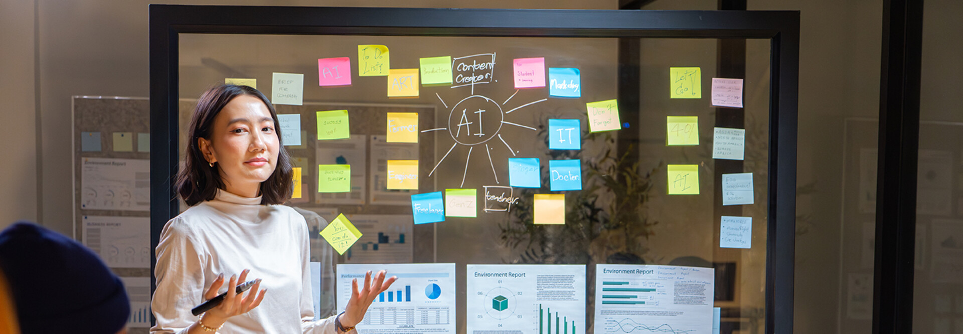 Biz Woman talking at a board with AI & charts