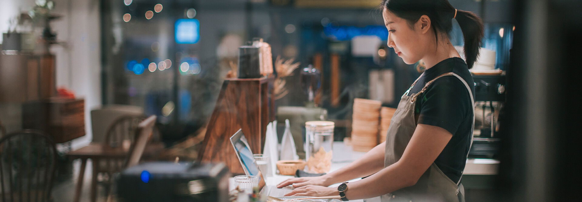 lady at counter on laptop