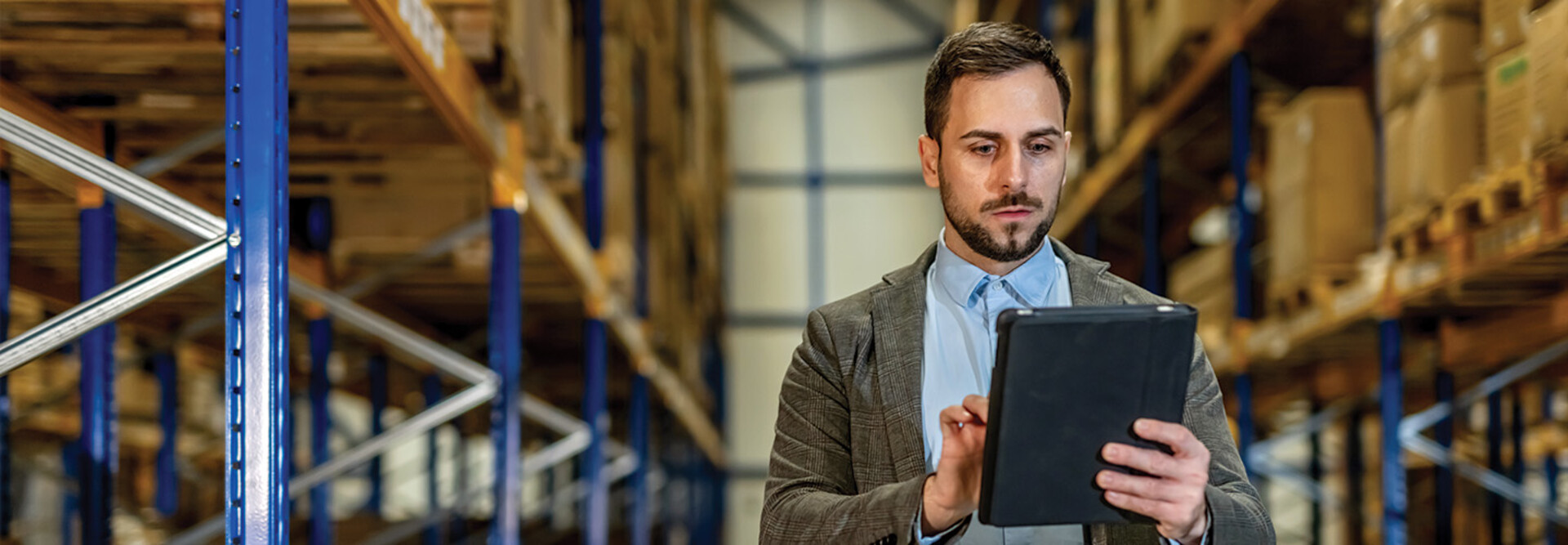 man on tablet in warehouse