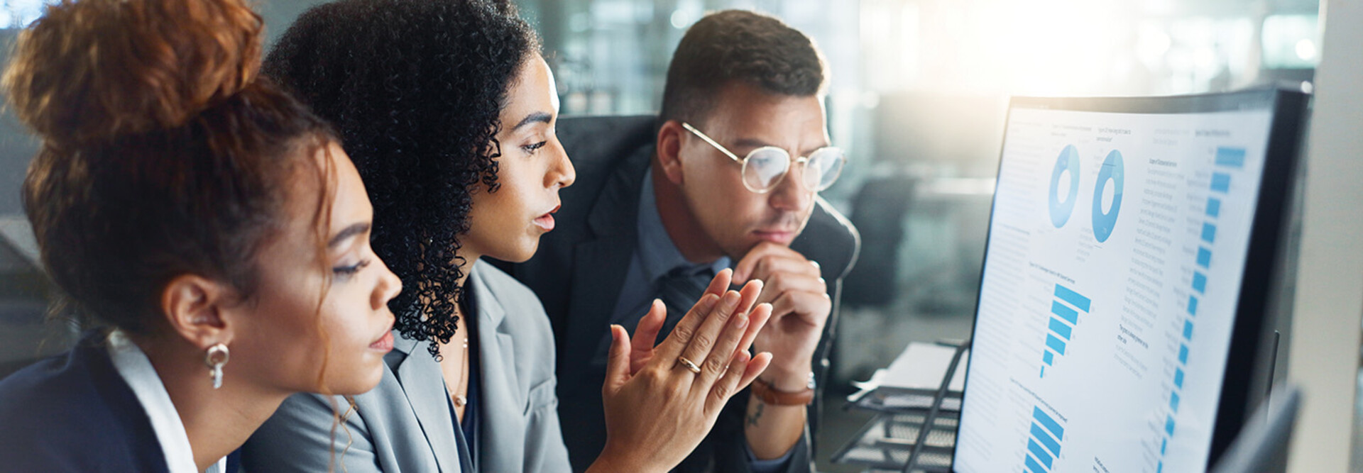 IT team looks at charts on monitor
