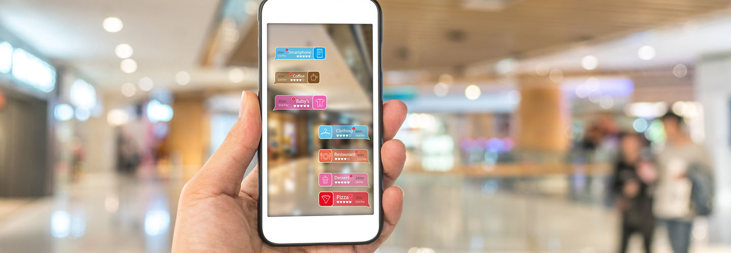 Augmented reality marketing in the shopping mall. Hand holding smart phone use AR application to check information