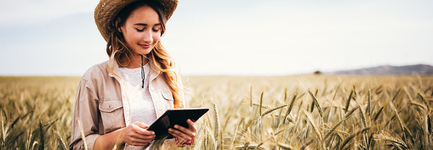 Girl in field with iPad