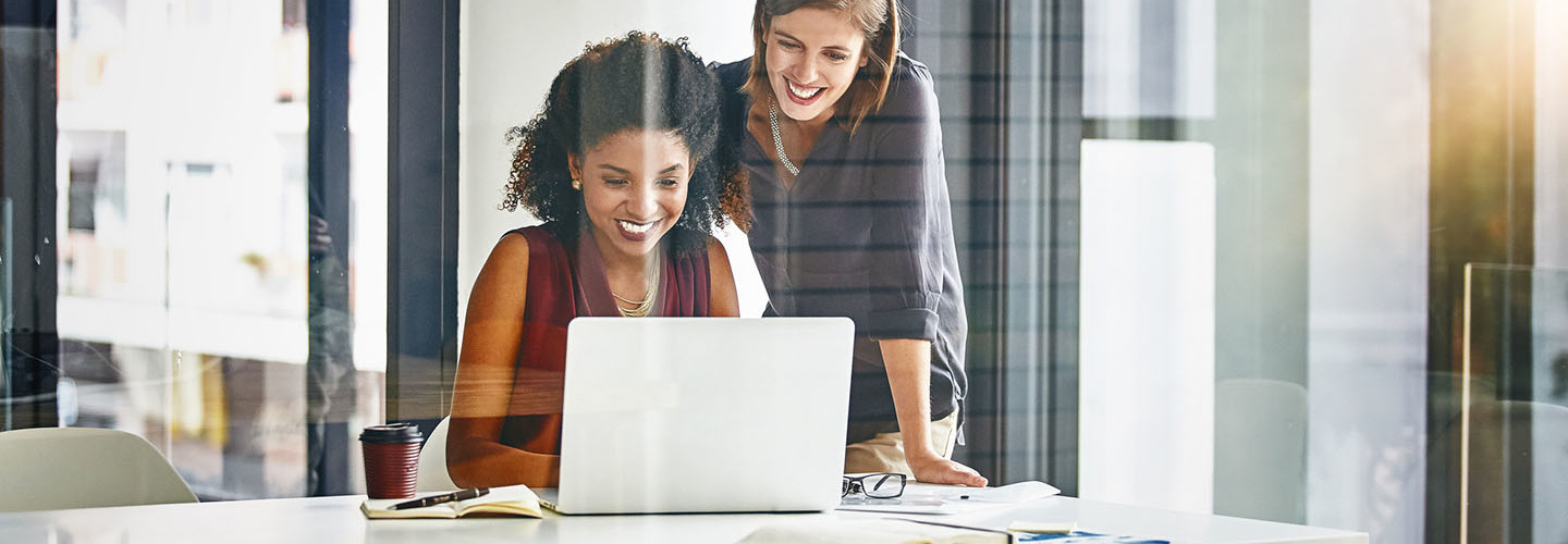  Cropped shot of two businesswomen working together on a laptop in an office