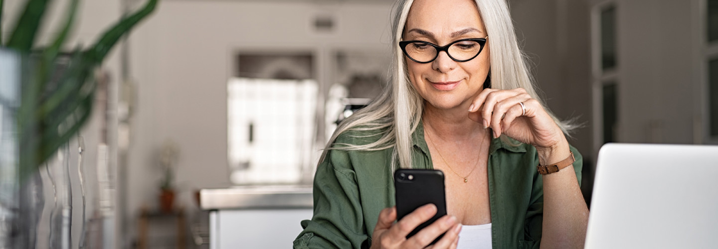 woman with iphone and mac thinking about user experience