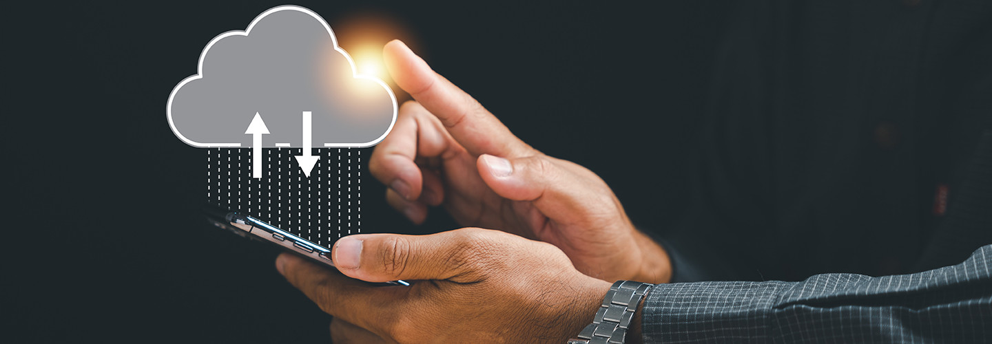 Innovative technology is at the businessman's fingertips as he touches the cloud icon.