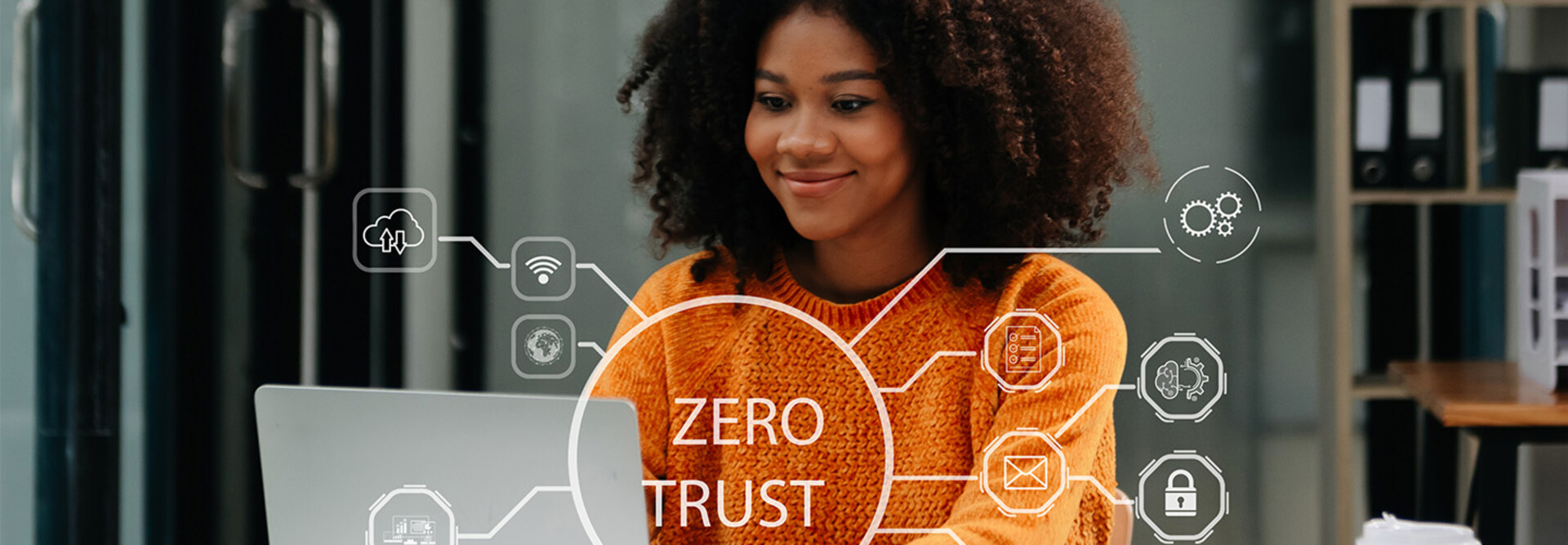 Person using computer and tablet with zero trust icon