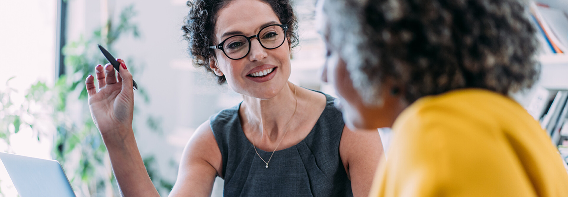 Two females talking in an office