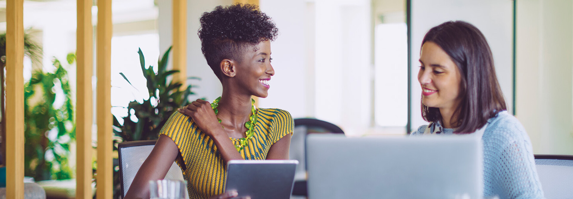 small business owners smile around computer