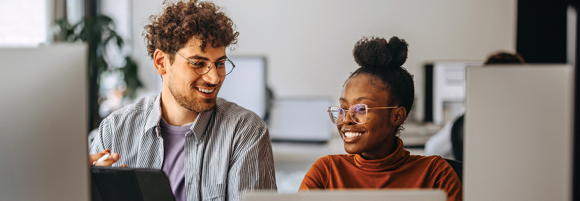 coworkers at an office collaborate