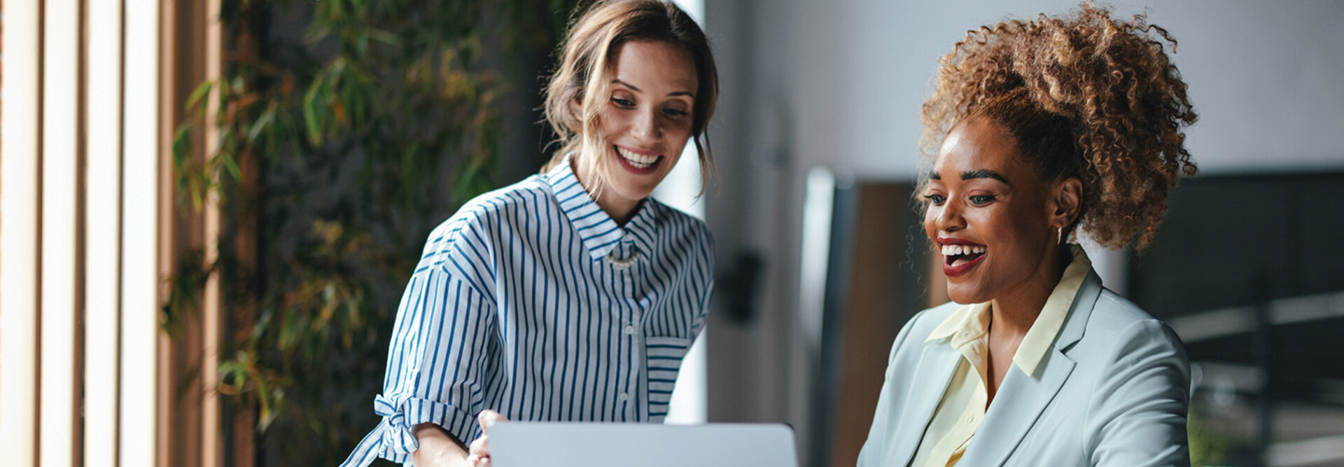 Two businesswomen viewing a laptop 