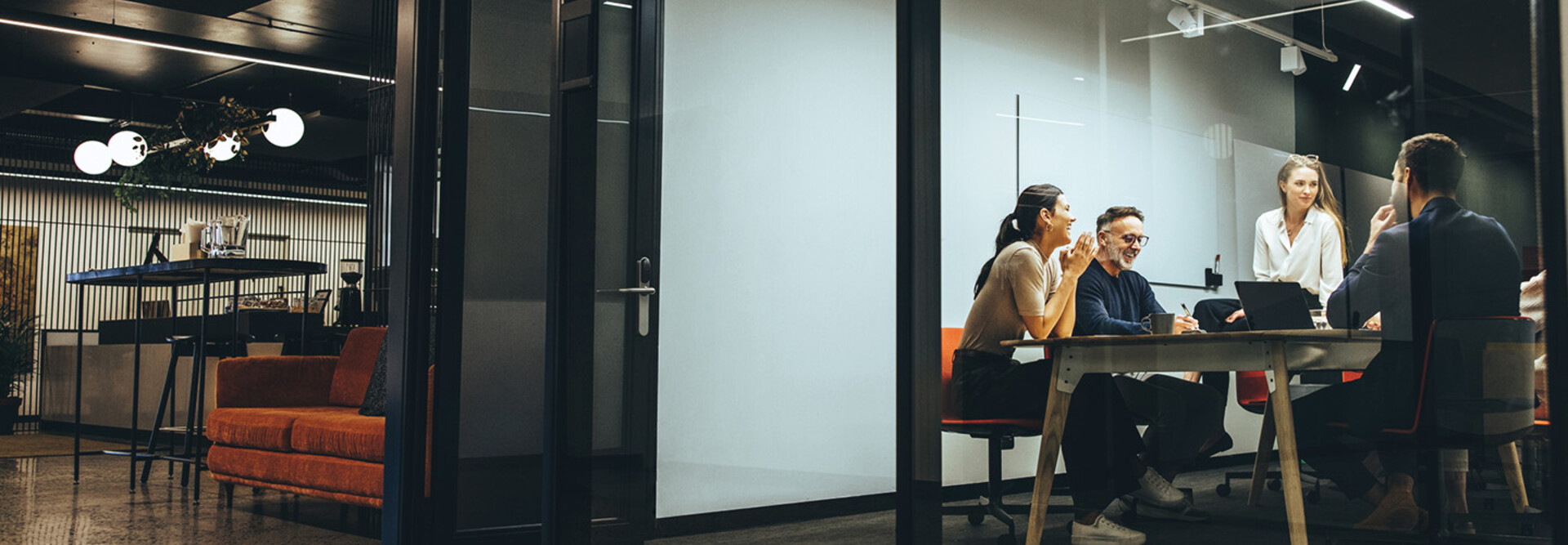 A group of employees gather in a meeting room