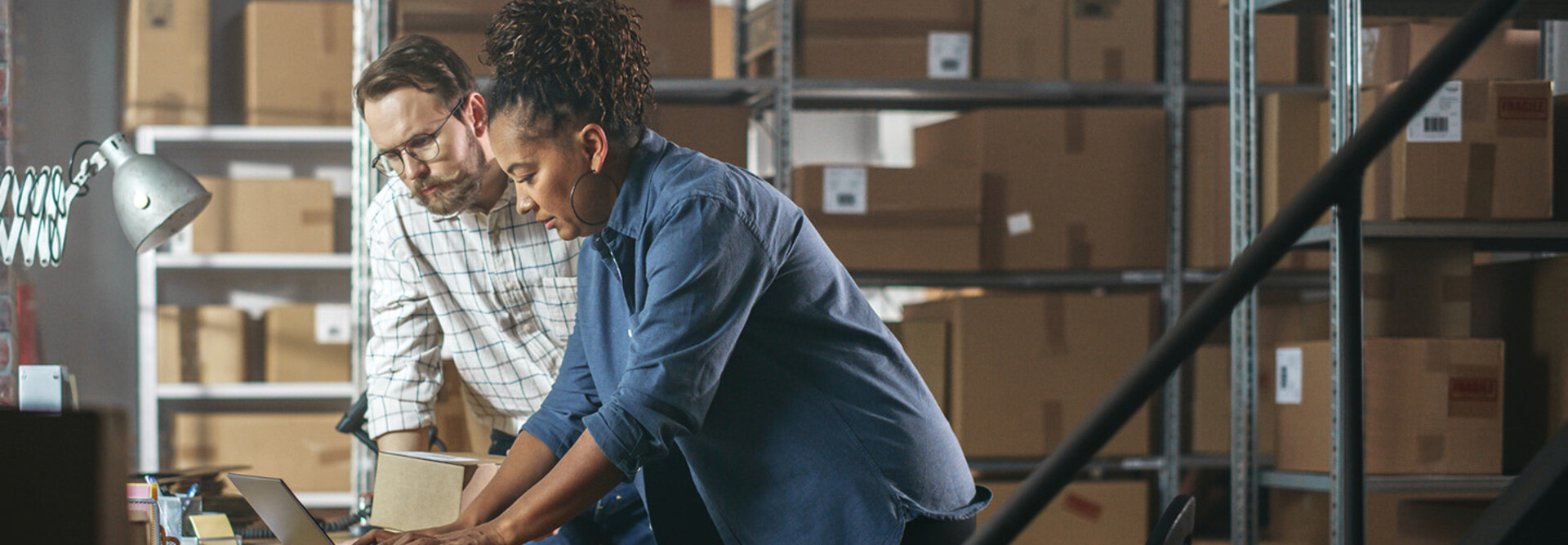 Two business owners in a warehouse