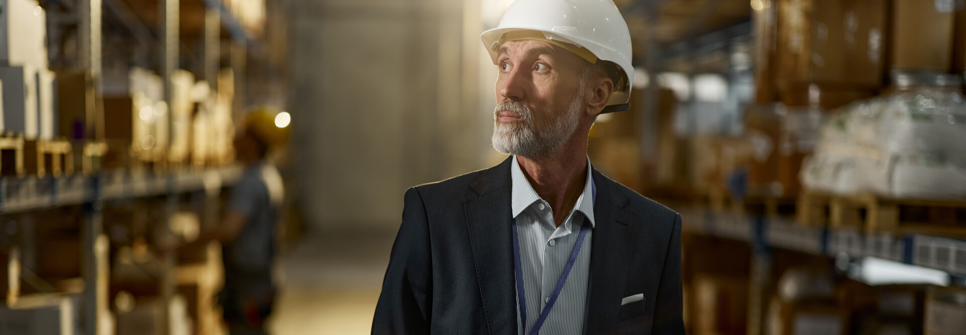 Man in hardhat looking in warehouse