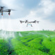 Drones flying over agricultural landscape