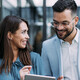 Business people using digital tablet outdoors