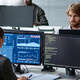 Young IT Developers Working with Multiple Computers