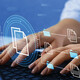 woman's hands typing on laptop