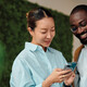 IT leaders holding an android phone in workspace
